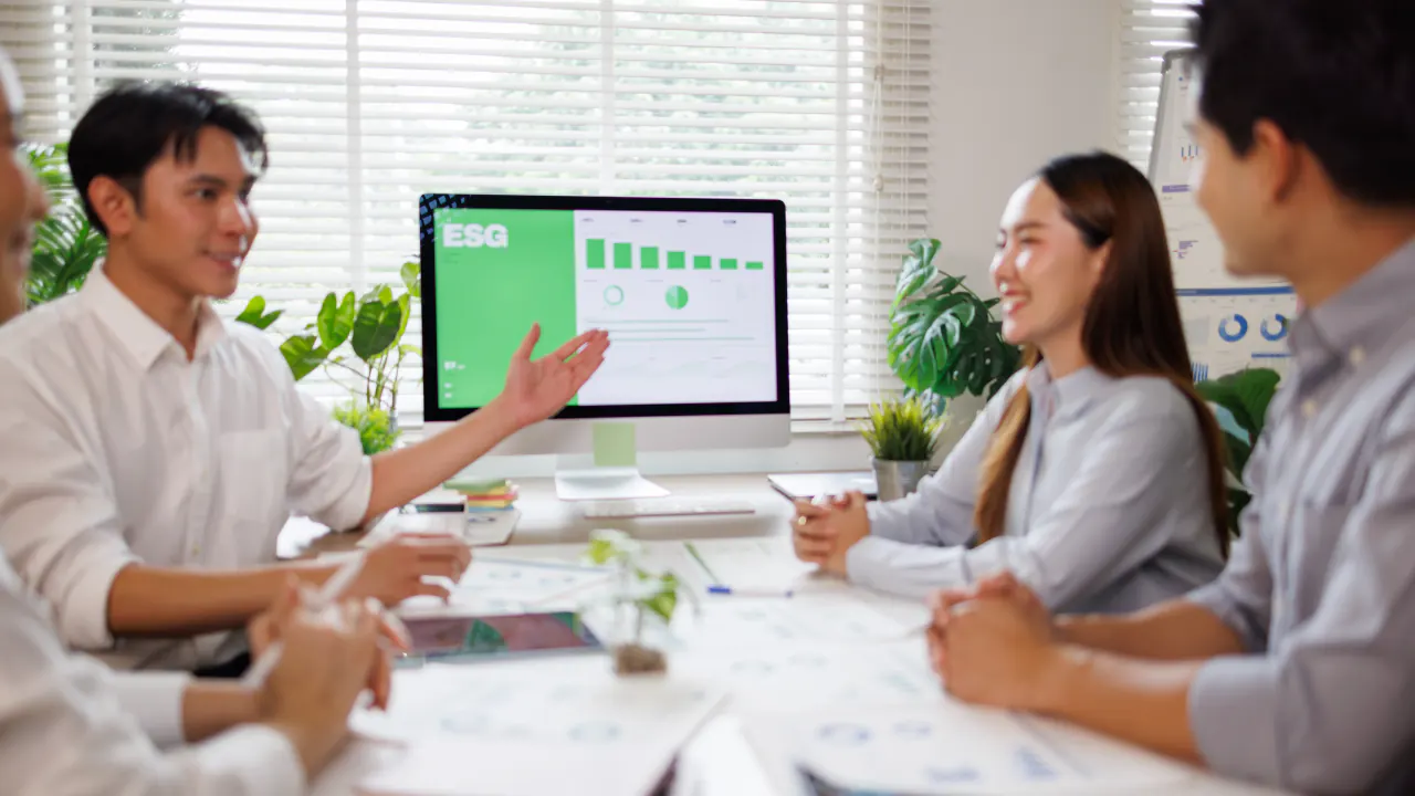 Colleagues reviewing a growth dashboard in a bright meeting room, illustrating how appointment setting drives business growth