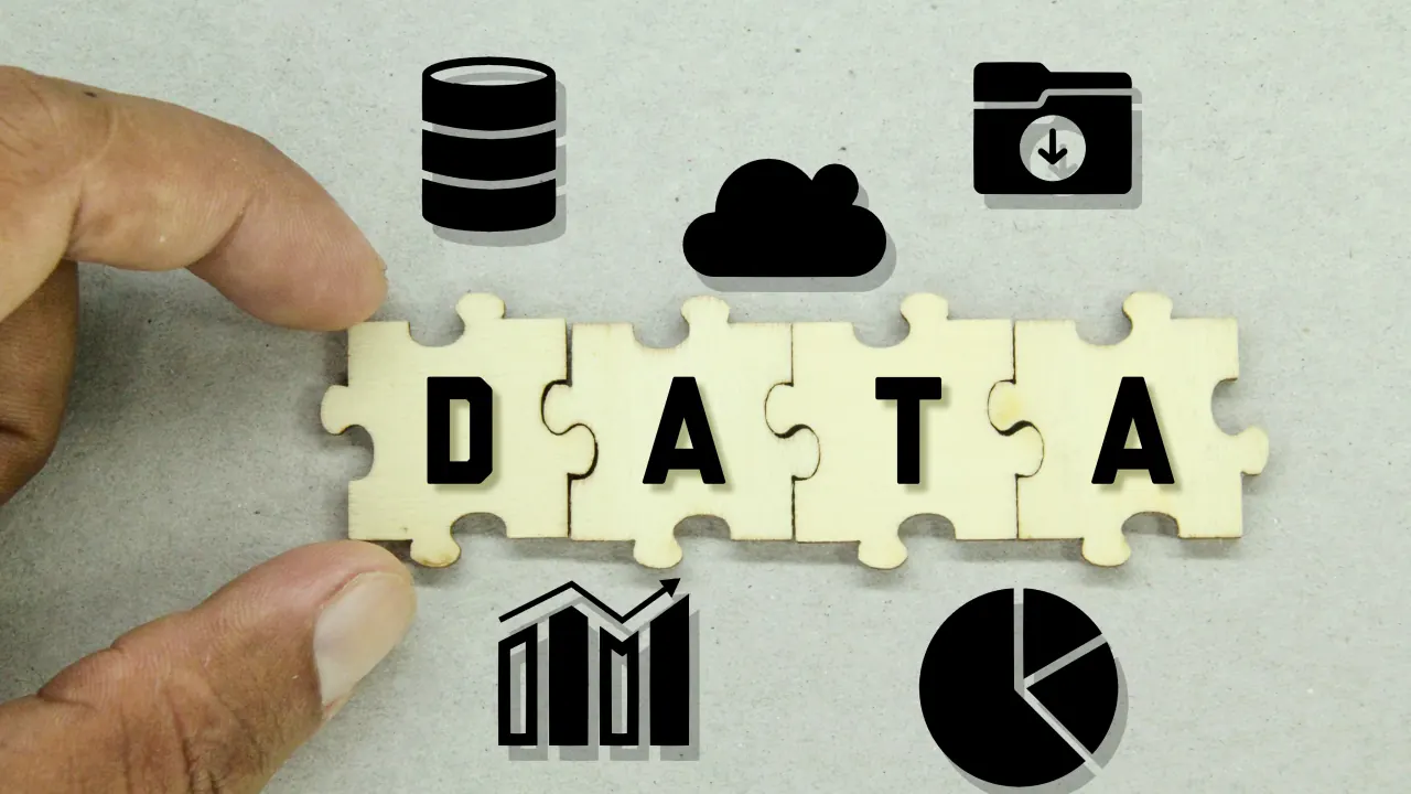 Puzzle pieces spelling DATA with database and chart icons, illustrating B2B data for sales teams