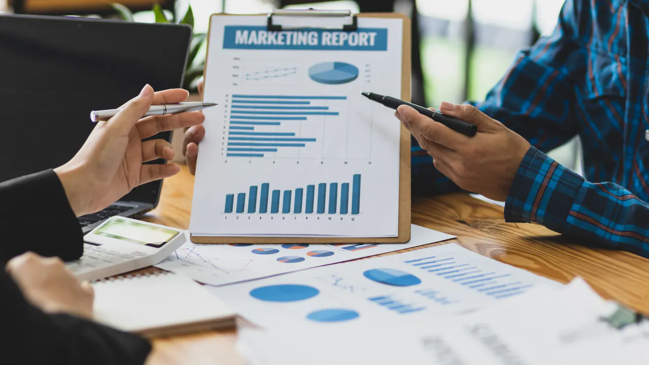 Marketing report with bar charts on a clipboard, illustrating key metrics to track for lead generation