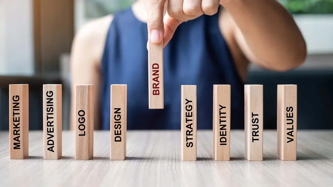 Wooden blocks labeled brand, strategy, identity and trust, illustrating brand positioning