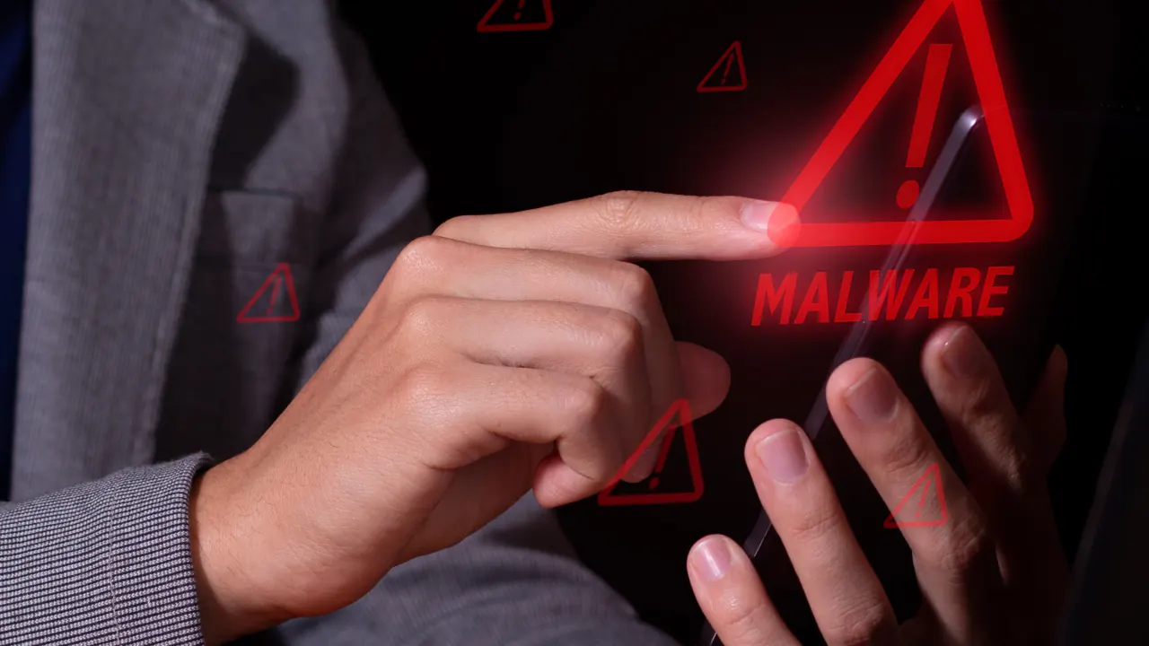 Finger touching a red malware warning screen, illustrating how to avoid fraudulent lead sellers
