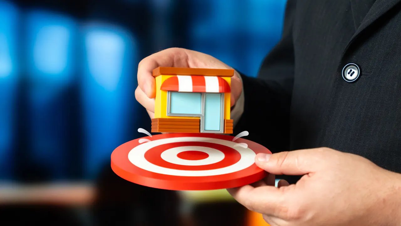 Hand placing a storefront on a target, illustrating contextual marketing for B2B lead generation