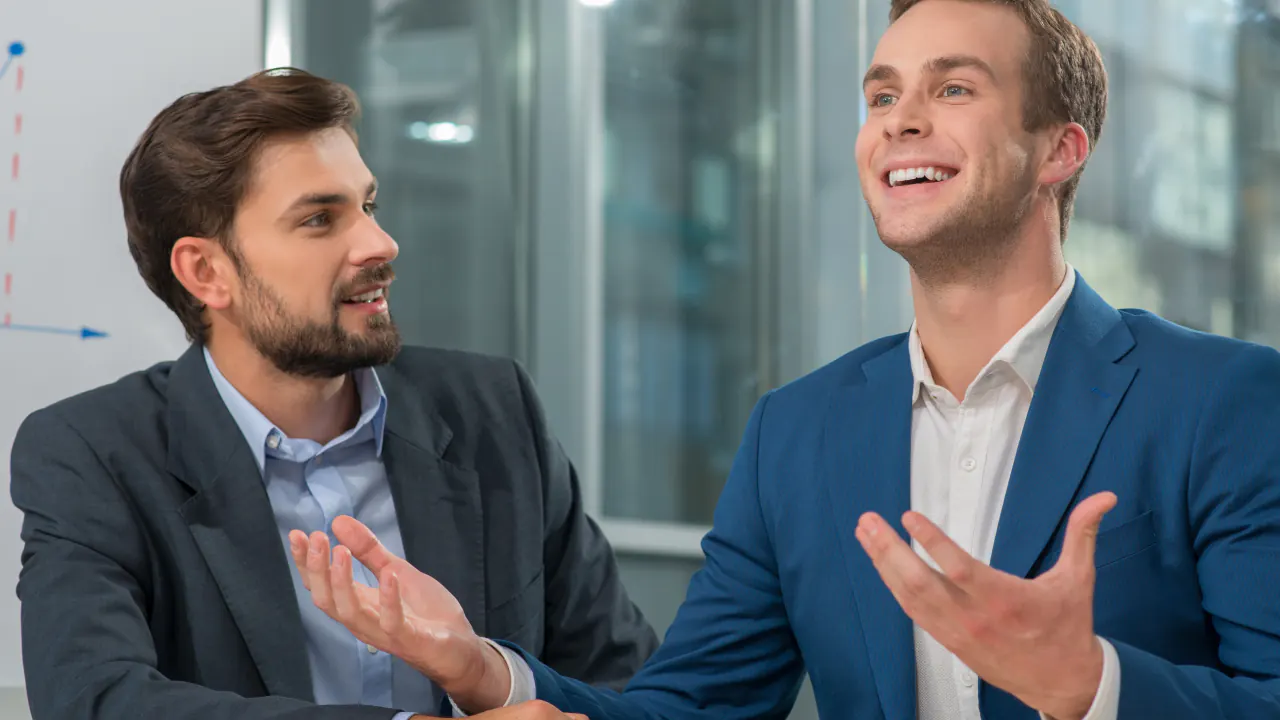 Two businessmen in a lively conversation, illustrating a conversation qualified lead