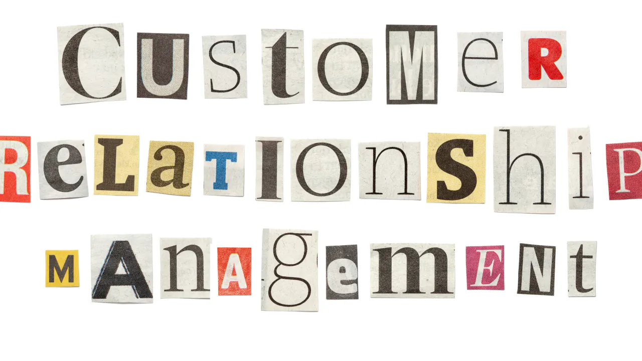 Cut-out letters spelling Customer Relationship Management, illustrating CRM