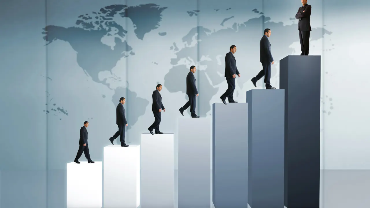 Businessmen climbing rising bar steps on a world map, illustrating customer expansion