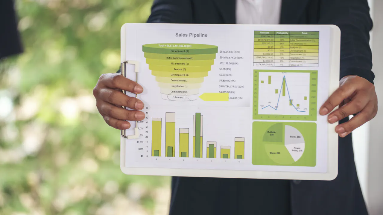 Presenter holding a tablet with a sales pipeline funnel chart, illustrating demand gen vs. lead gen