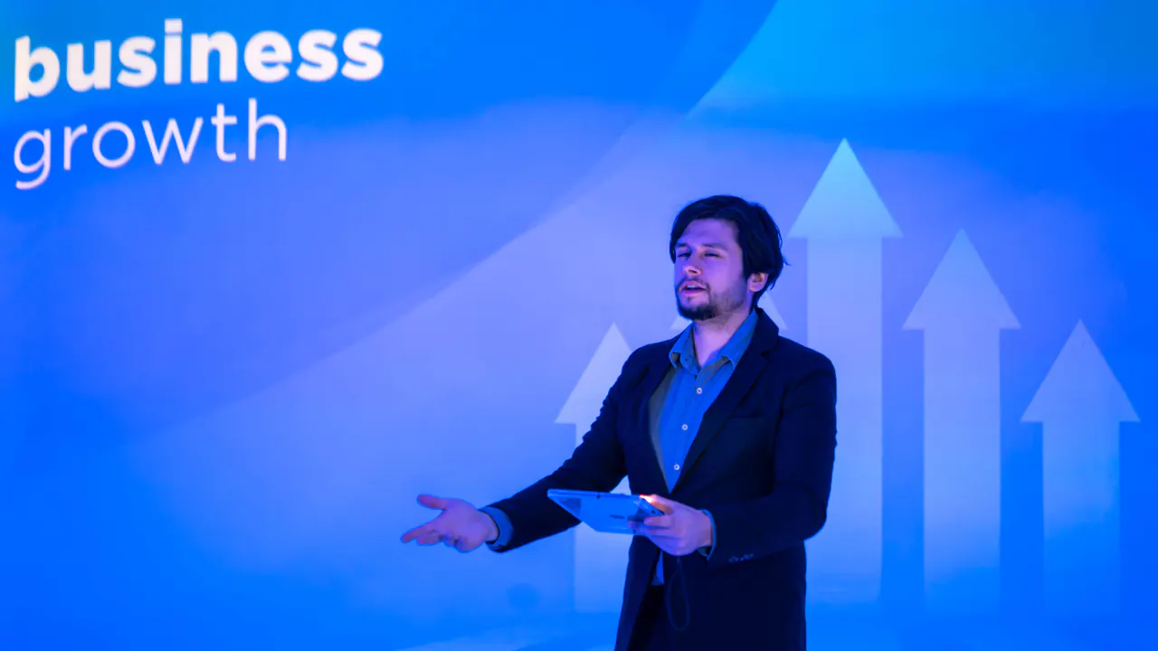 Presenter beside rising blue arrows labeled business growth, illustrating ways to enhance enterprise lead generation