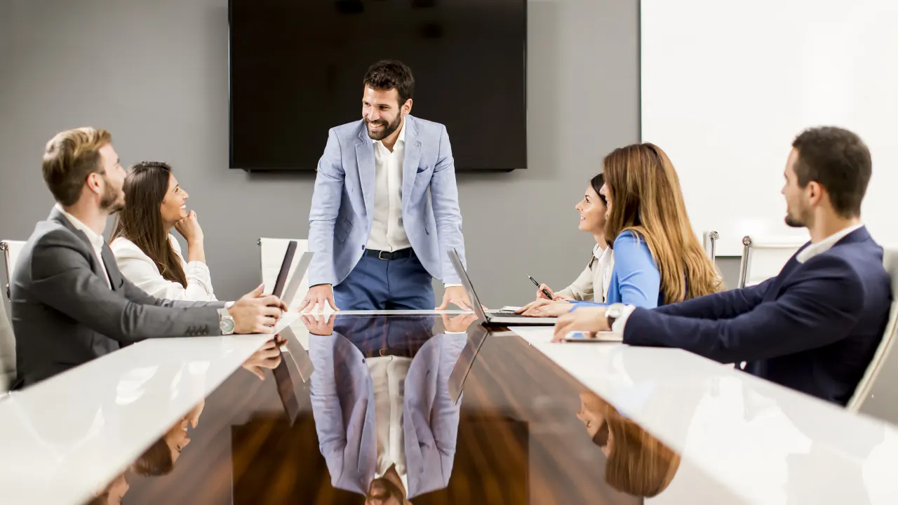Team meeting around a glossy conference table, illustrating key components of an enterprise sales strategy