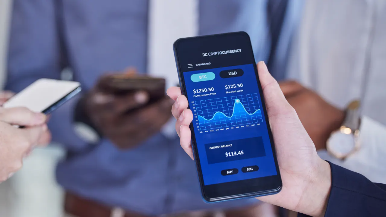 Hand holding a smartphone with a financial app, illustrating B2B lead generation for fintech companies