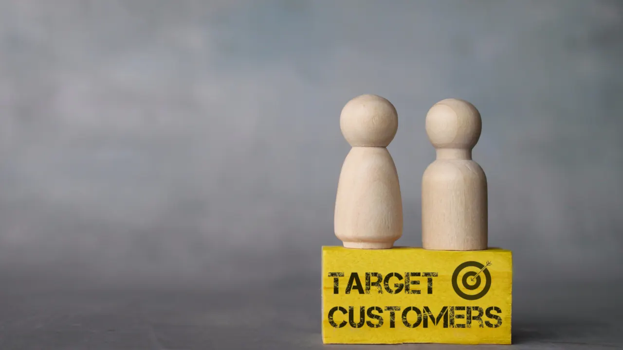 Wooden figures on a Target Customers block, illustrating ICP marketing and ideal customer profiles