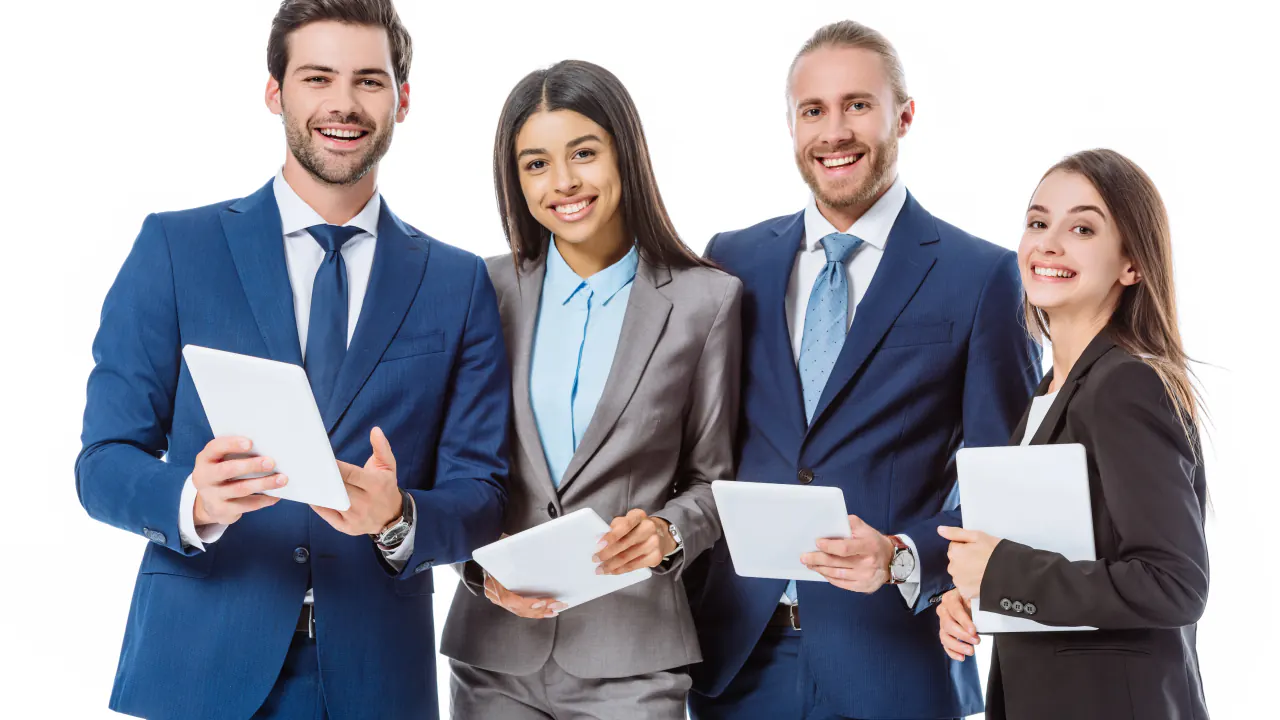 Four smiling business professionals holding tablets, illustrating the advantages of outsourcing lead generation