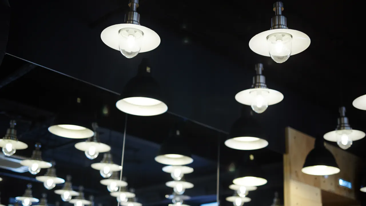 Rows of pendant lights hanging from a ceiling, illustrating sales in the lighting market