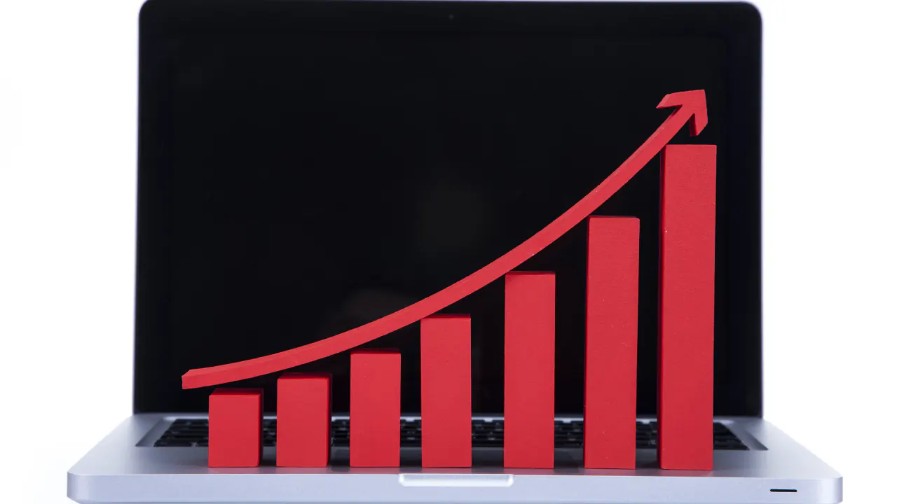 Laptop with a red rising bar chart, illustrating list growth rate