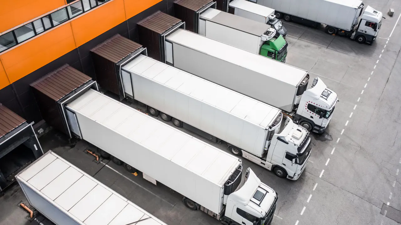 Aerial view of semi trucks at a loading dock, illustrating logistics lead generation