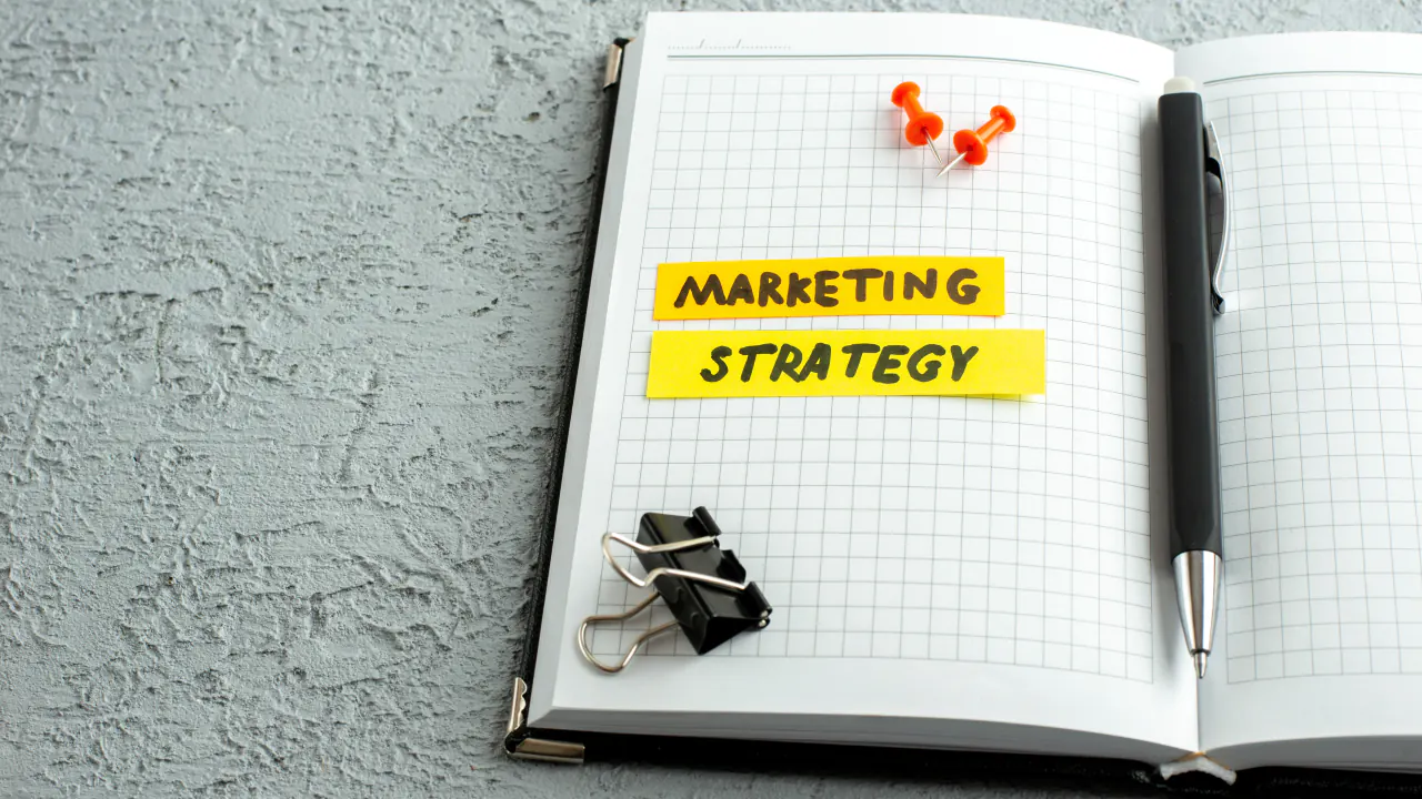 Notebook with a marketing strategy sticky note, illustrating enterprise marketing playbooks