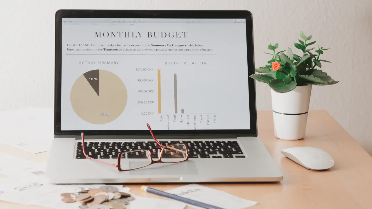 Laptop showing a monthly budget pie chart, illustrating monthly recurring revenue (MRR) tracking