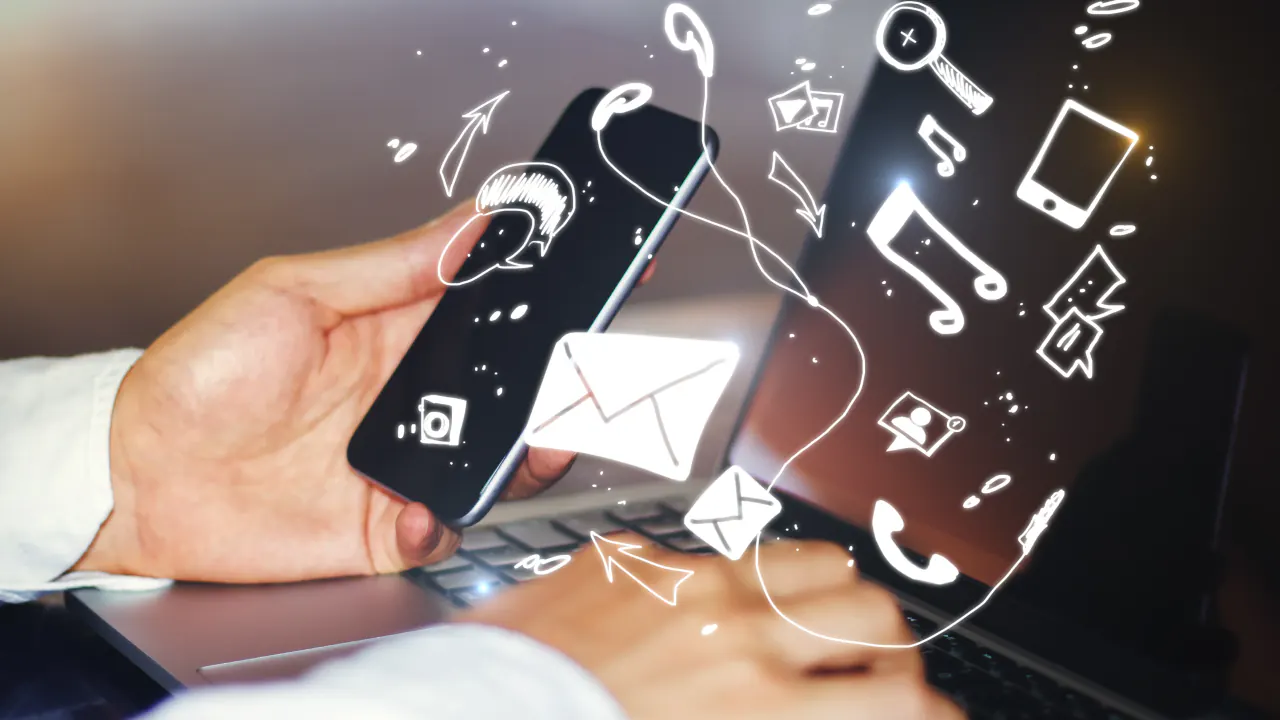 Hand holding a smartphone with email and communication icons, illustrating a multi-touch engagement approach