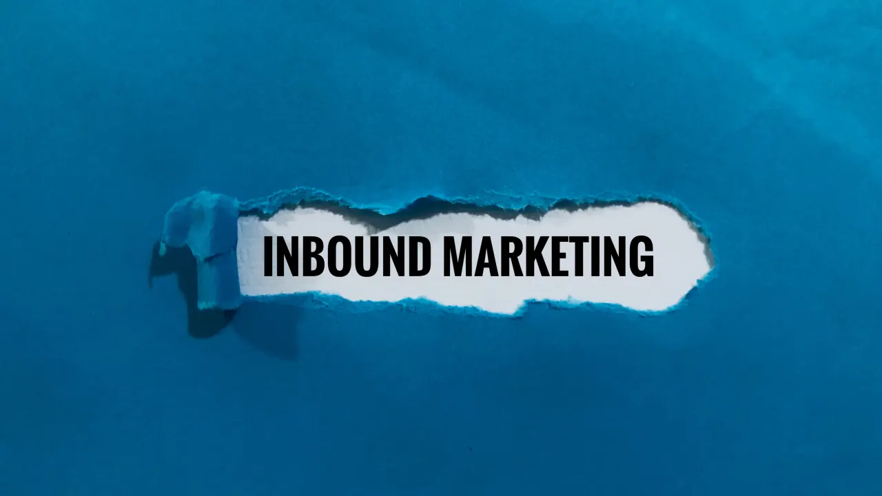 Inbound Marketing text on torn blue paper, illustrating outbound vs. inbound marketing