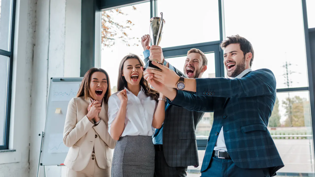 Sales team celebrating with a trophy, illustrating sales contest ideas to motivate your team