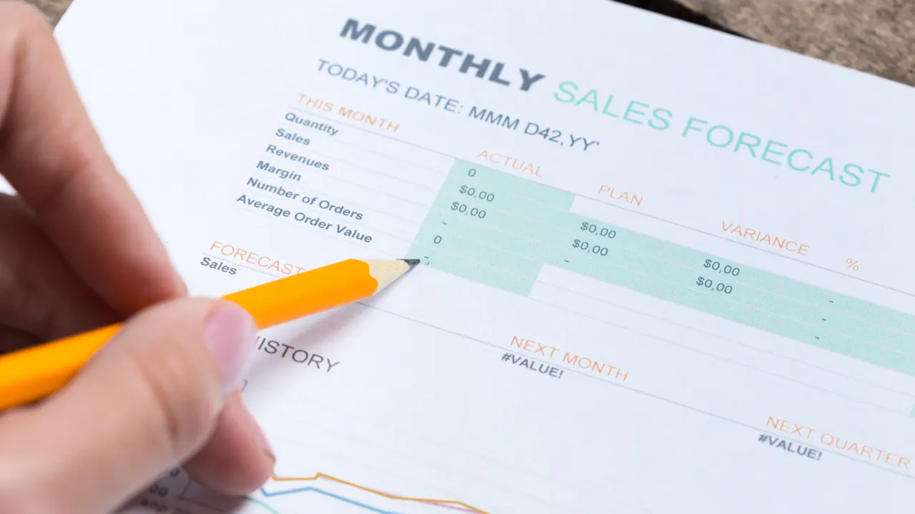 Pencil on a monthly sales forecast sheet, illustrating sales forecasting