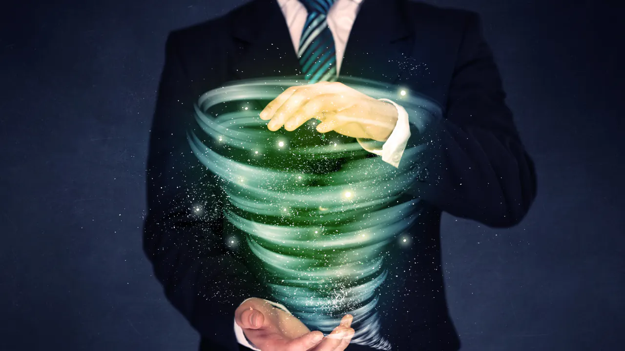Businessman holding a glowing vortex in his hands, illustrating the B2B sales funnel