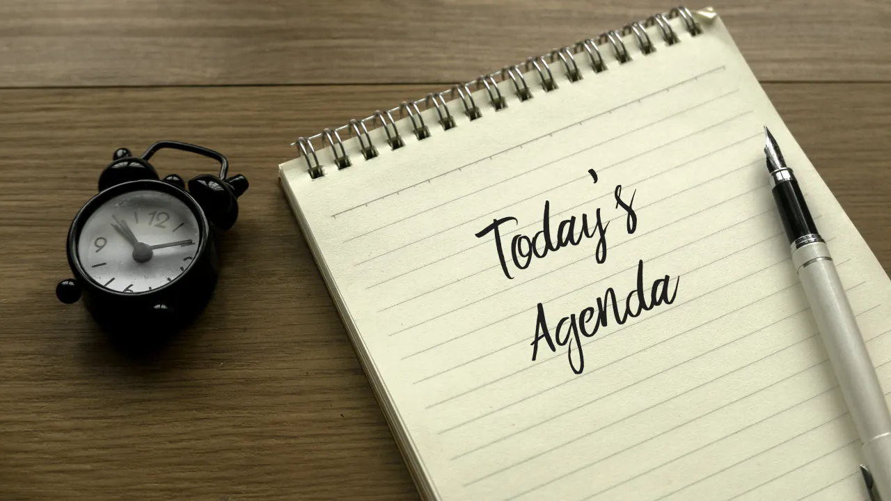 Notebook with Today's Agenda beside a clock, illustrating a successful sales meeting agenda