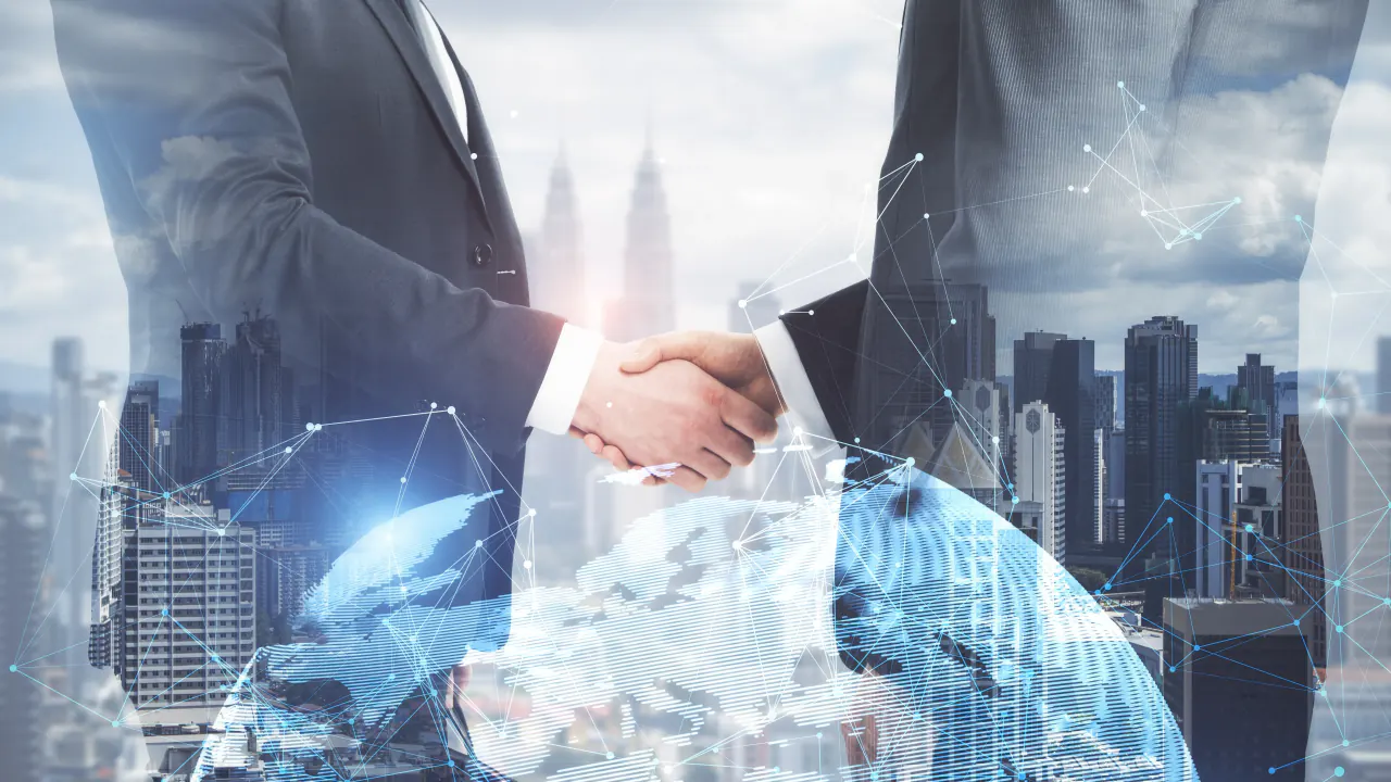 Business handshake over a city and globe overlay, illustrating sales outsourcing to boost revenue