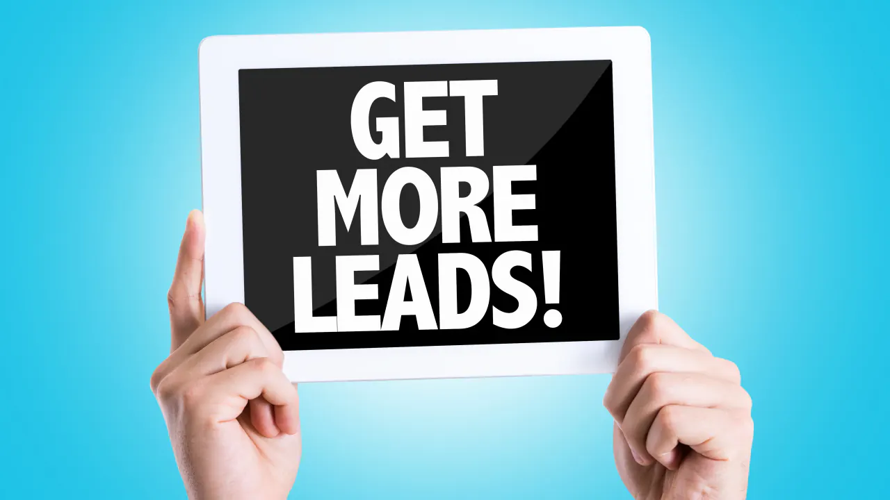 Hands holding a tablet reading Get More Leads, illustrating Sandler sales training