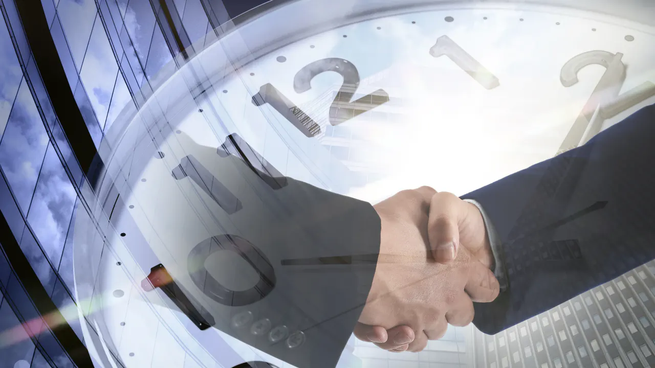 Handshake over a clock face, illustrating how to shorten your sales cycle with GenSales