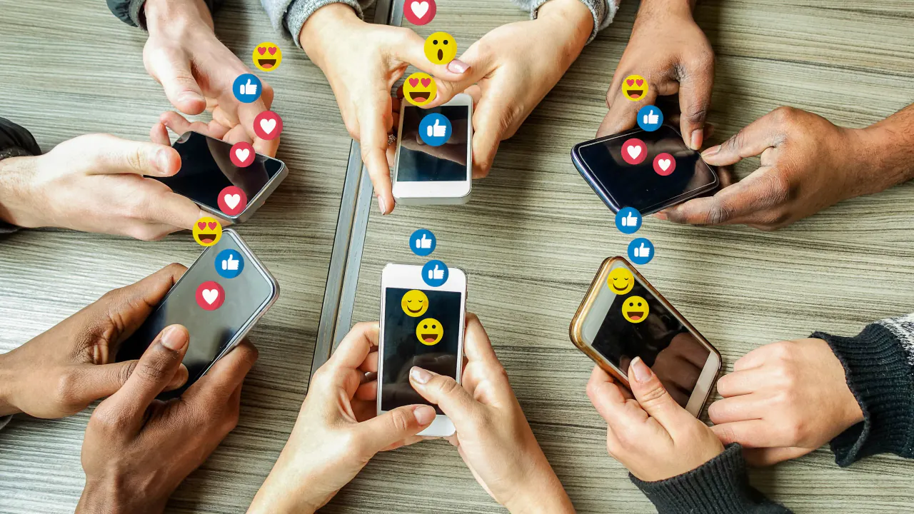 Hands holding phones with like and heart icons, illustrating social media engagement for lead generation