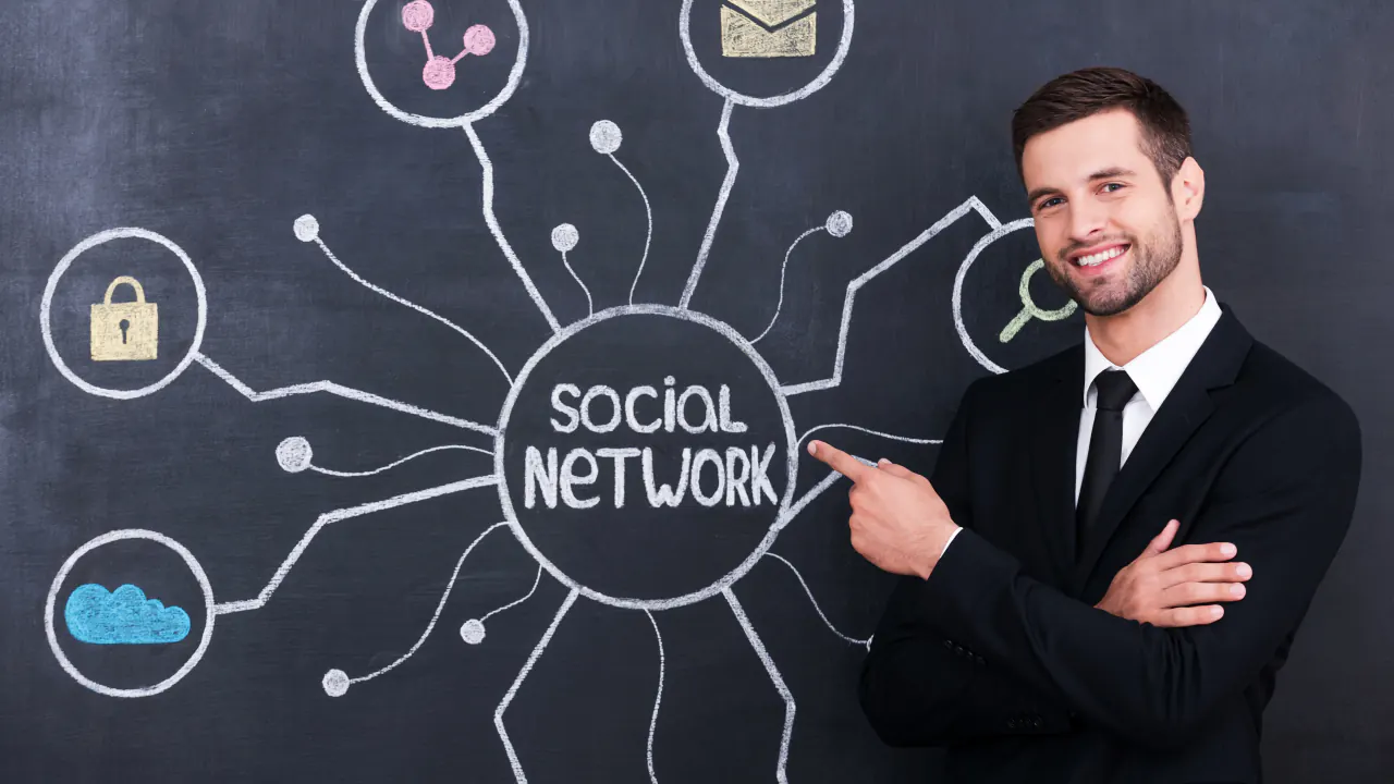 Smiling businessman pointing at a social network diagram, illustrating social selling for B2B sales