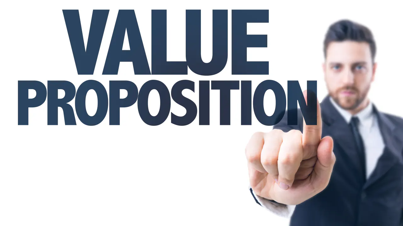 Businessman pointing at the words Value Proposition, illustrating how to write a value proposition